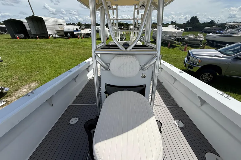 Slide: The Image of 1981 T Craft Gulfstream 30 boat interior with seating and console, parked on grassy area. - 60