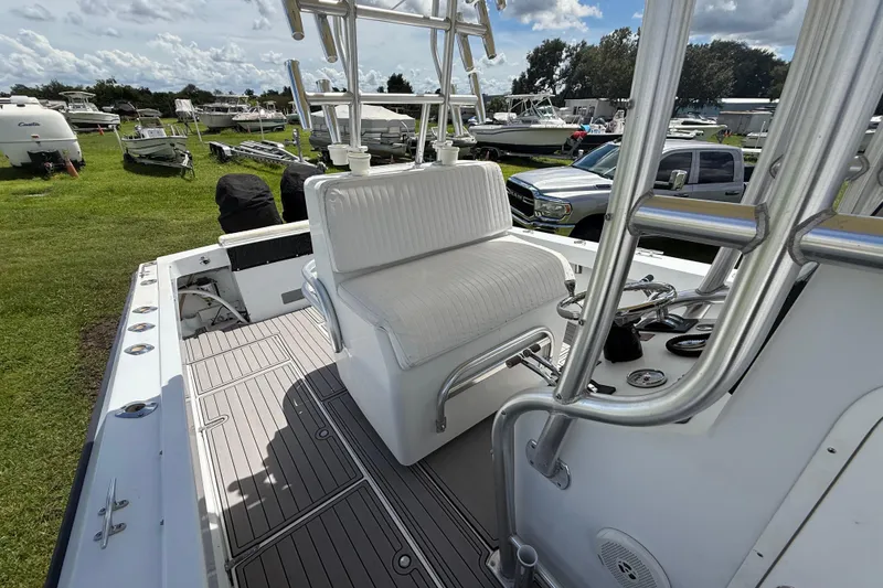 Slide: The Image of 1981 T Craft Gulfstream 30 boat interior with white seating and steering wheel, parked outdoors. - 63