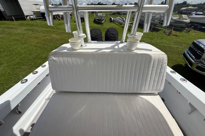 Slide: The Image of 1981 T Craft Gulfstream 30 boat interior with white cushioned seating and cup holders. - 66