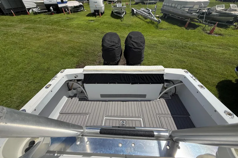 Slide: The Image of 1981 T Craft Gulfstream 30 boat deck with covered engines, parked on grass. - 67