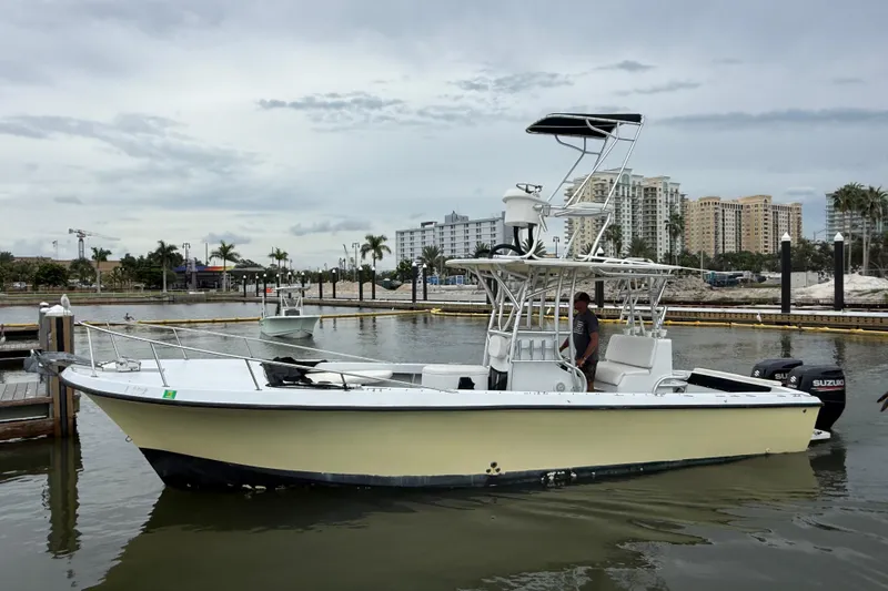 Slide: The Image of 1981 T Craft Gulfstream 30 boat docked in marina, with cityscape background. - 7