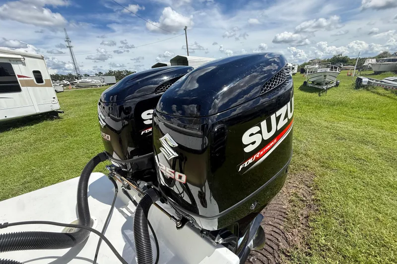 Slide: The Image of Twin Suzuki outboard motors on a 1981 T Craft Gulfstream 30 boat, parked on grass. - 71