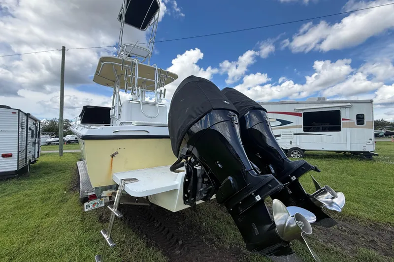 Slide: The Image of 1981 T Craft Gulfstream 30 boat with dual outboard motors, parked on grass. - 72