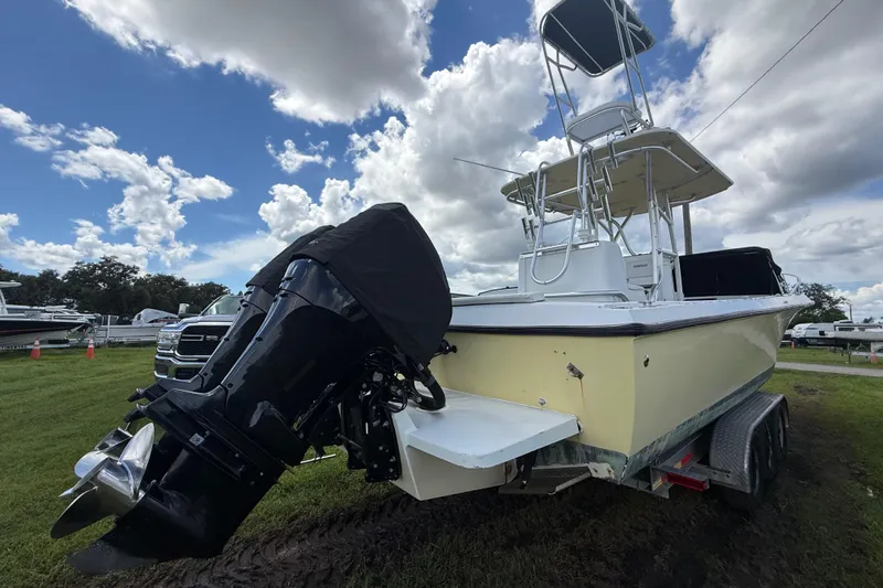 Slide: The Image of 1981 T Craft Gulfstream 30 boat with outboard motor on trailer under cloudy sky. - 73