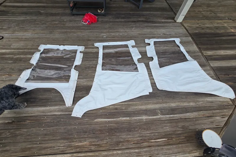 Slide: The Image of Clear boat canvas panels for 1981 T Craft Gulfstream 30 on wooden deck. - 74