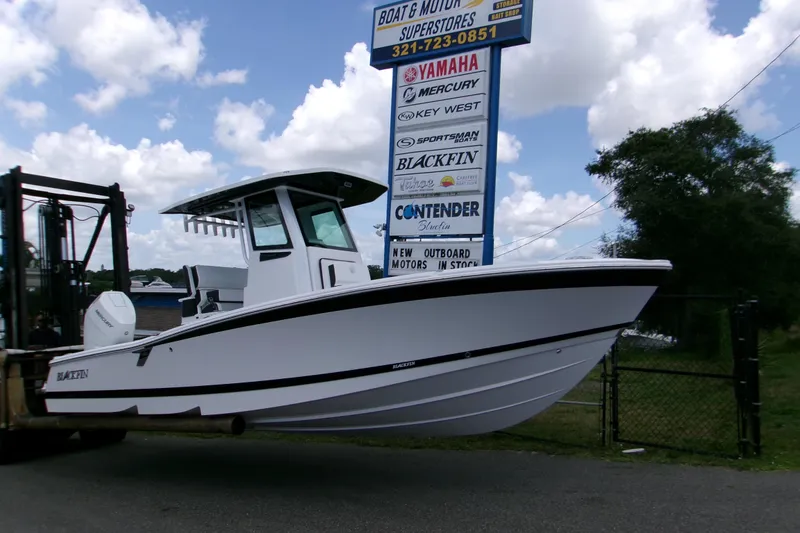 The Image of 2026 Blackfin 262 HB boat displayed outdoors near dealership sign. - 1