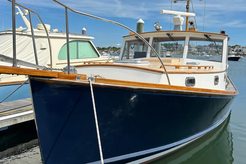 Slide: The Image of 1994 John Williams Stanley 36 boat docked in a marina under clear blue skies. - 12