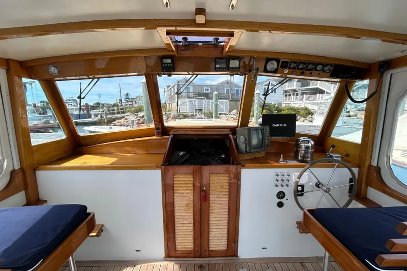 Slide: The Image of Interior of a 1994 John Williams Stanley 36 boat with wooden accents and navigation equipment. - 4