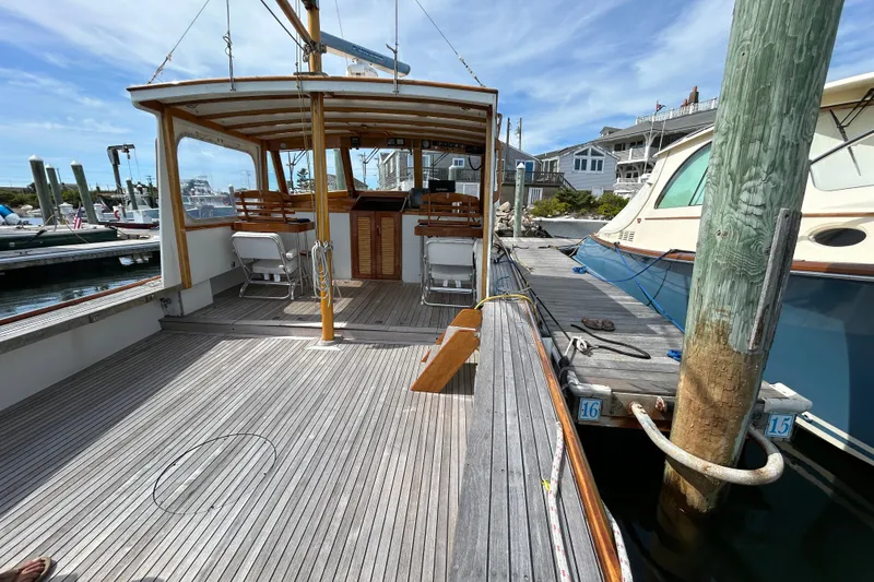 Slide: The Image of Wooden deck of a 1994 John Williams Stanley 36 boat docked at a marina. - 7