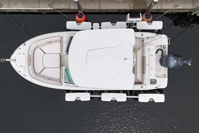 Slide: The Image of Overhead view of 2019 Robalo R247 Dual Console boat docked at marina. - 10