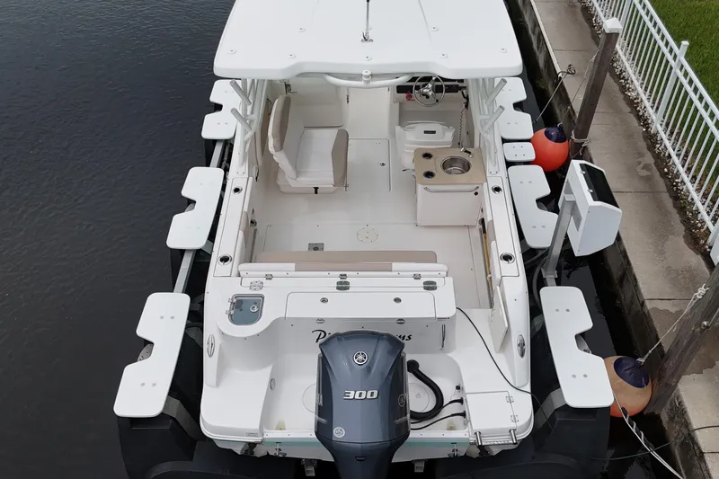 Slide: The Image of 2019 Robalo R247 Dual Console boat docked, featuring spacious seating and Yamaha 300 engine. - 11