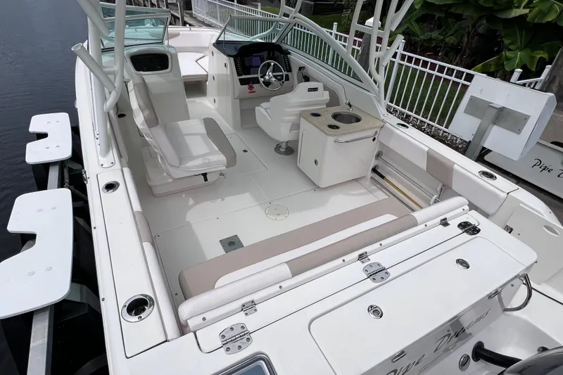 Slide: The Image of 2019 Robalo R247 Dual Console boat interior with seating and helm station. - 25
