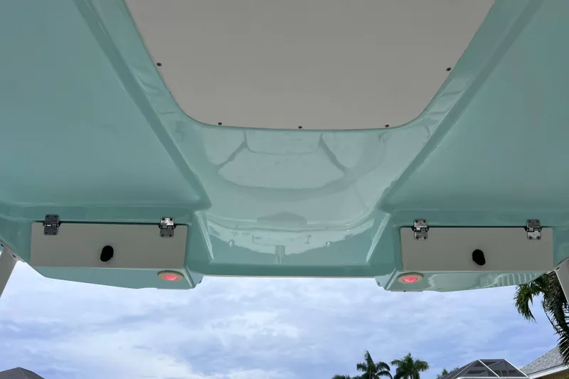 Slide: The Image of 2019 Robalo R247 Dual Console boat underside with sky and palm trees. - 30
