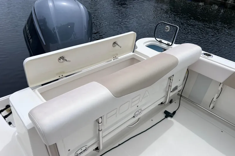 Slide: The Image of 2019 Robalo R247 Dual Console boat with Yamaha engine, featuring spacious seating and storage. - 32