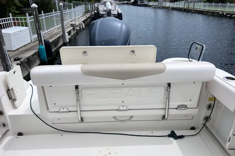 Slide: The Image of 2019 Robalo R247 Dual Console boat interior with seating and engine view. - 34