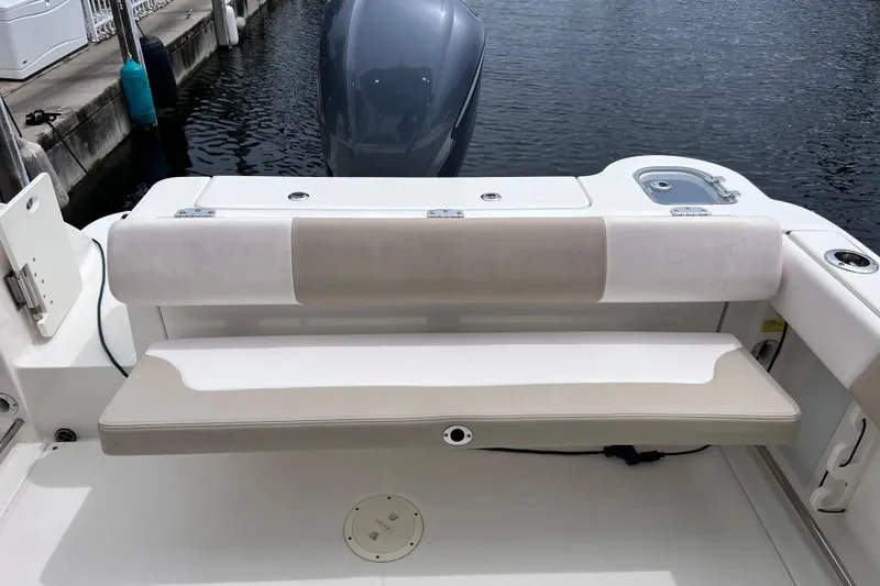 Slide: The Image of 2019 Robalo R247 Dual Console boat with cushioned seating and outboard motor. - 35