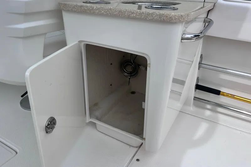 Slide: The Image of Open storage compartment on 2019 Robalo R247 Dual Console boat. - 43