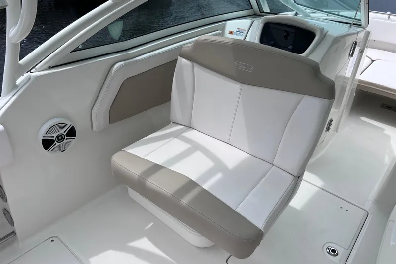 Slide: The Image of 2019 Robalo R247 Dual Console boat interior with cushioned seating and speaker. - 44