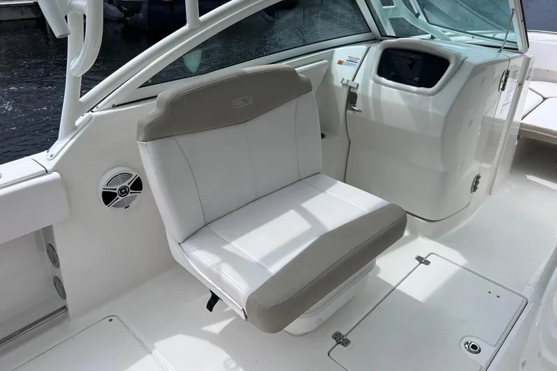 Slide: The Image of 2019 Robalo R247 Dual Console boat interior with white seating and dashboard. - 45