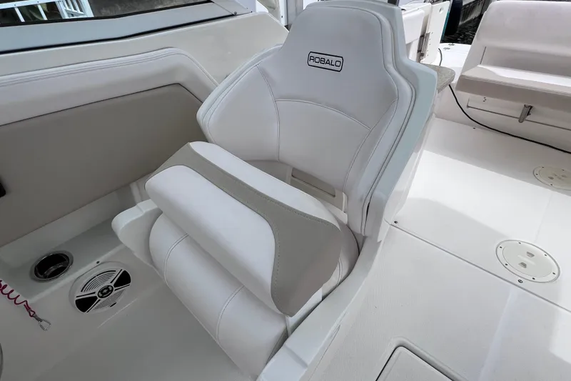 Slide: The Image of 2019 Robalo R247 Dual Console boat seat, white and gray upholstery, modern design. - 48