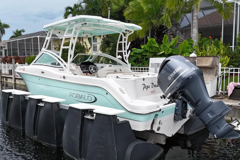 Slide: The Image of 2019 Robalo R247 Dual Console boat docked with Yamaha outboard motor. - 5