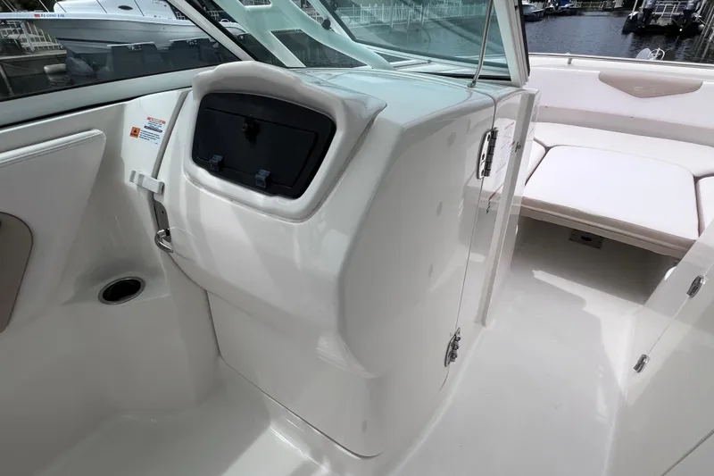 Slide: The Image of 2019 Robalo R247 Dual Console interior with seating and storage compartments. - 50