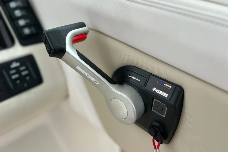 Slide: The Image of Throttle control lever on a 2019 Robalo R247 Dual Console boat. - 57