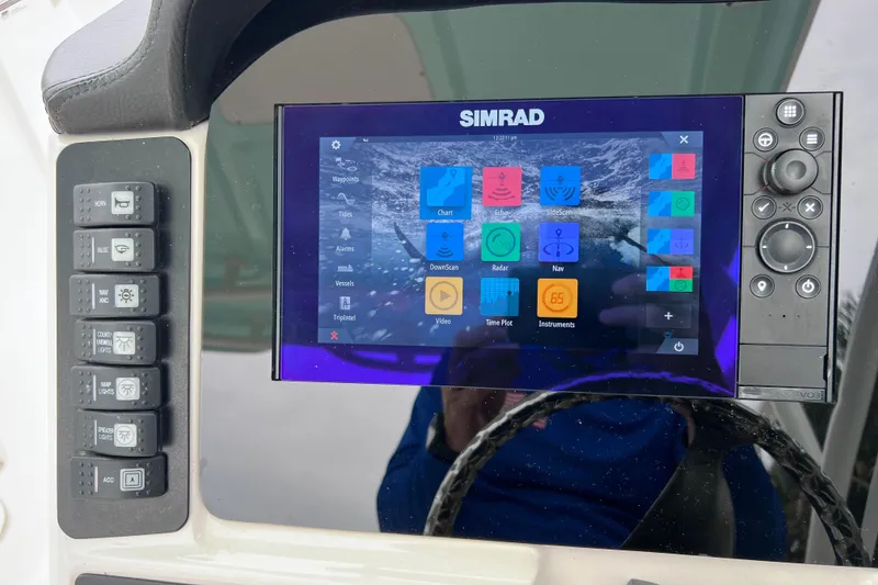 Slide: The Image of Simrad navigation system on 2019 Robalo R247 Dual Console boat dashboard. - 58