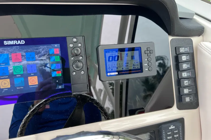 Slide: The Image of Dashboard of 2019 Robalo R247 Dual Console with Simrad and Yamaha displays. - 59