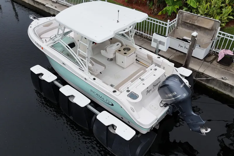 Slide: The Image of 2019 Robalo R247 Dual Console boat docked with Yamaha engine. - 9