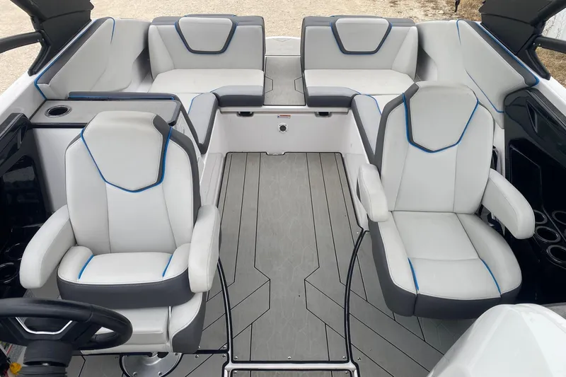 Slide: The Image of 2021 Yamaha Boats 252XE interior with modern white and gray seating, blue accents. - 11