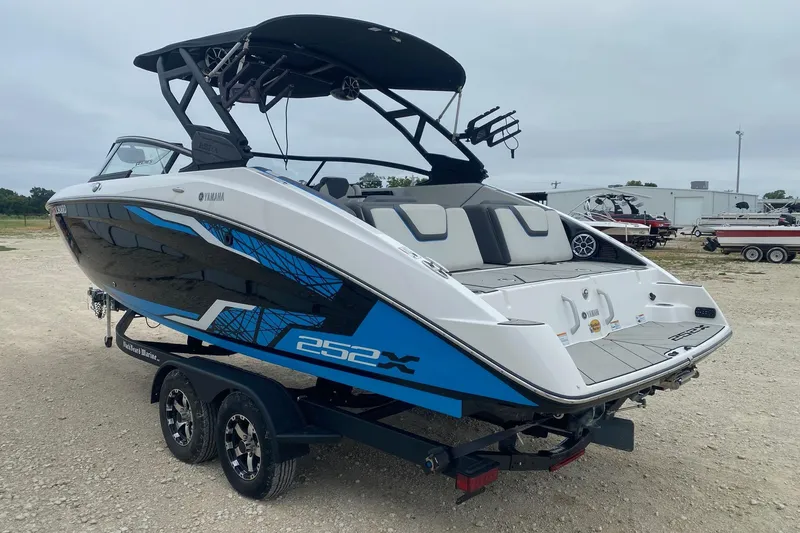 Slide: The Image of 2021 Yamaha Boats 252XE on trailer, featuring sleek design and modern graphics. - 3