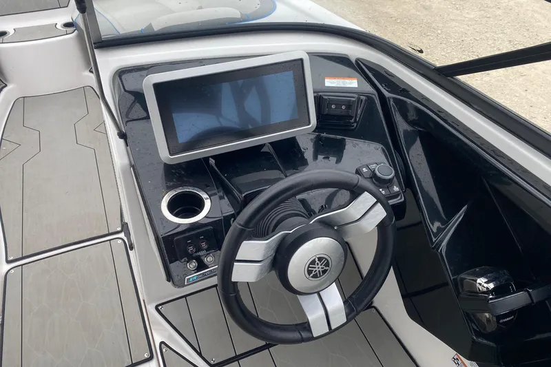 Slide: The Image of 2021 Yamaha Boats 252XE dashboard with steering wheel and touchscreen display. - 7
