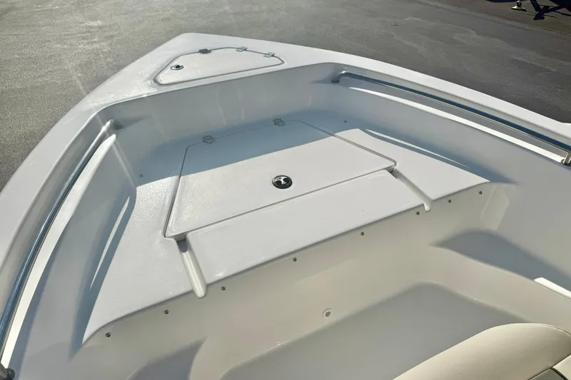 Slide: The Image of 2026 Key West 189 FS boat bow area with storage compartment and seating. - 11
