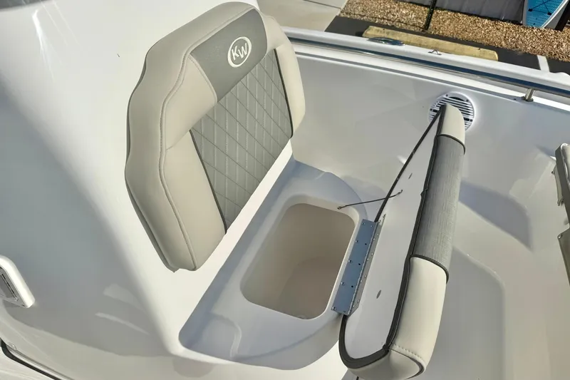Slide: The Image of 2026 Key West 189 FS boat seat with storage compartment, featuring gray and beige upholstery. - 16