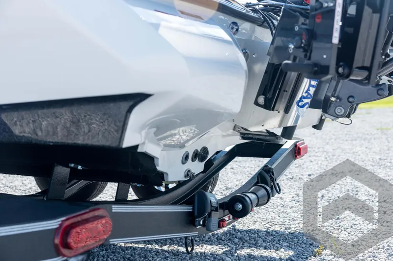 Slide: The Image of 2026 Skeeter ZXE21 boat trailer detail on gravel surface. - 25