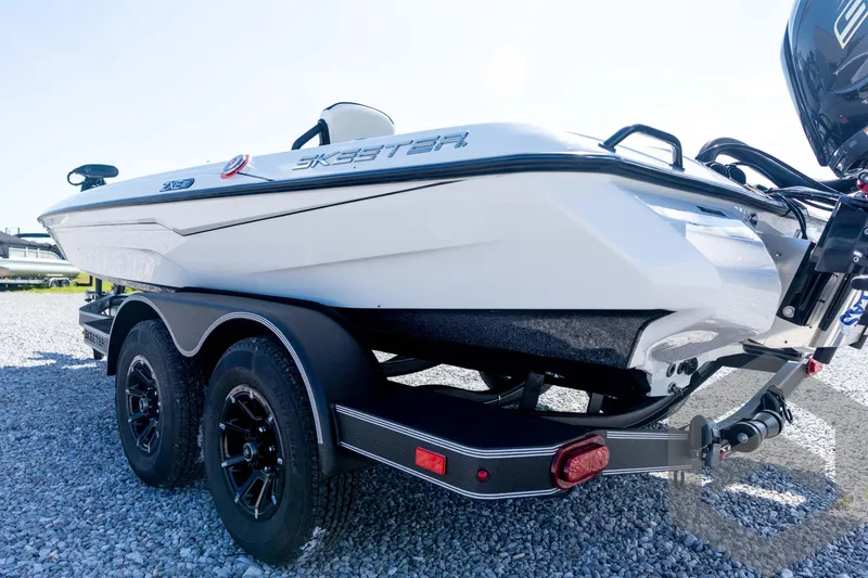 Slide: The Image of 2026 Skeeter ZXE21 boat on trailer, white exterior, parked on gravel. - 26