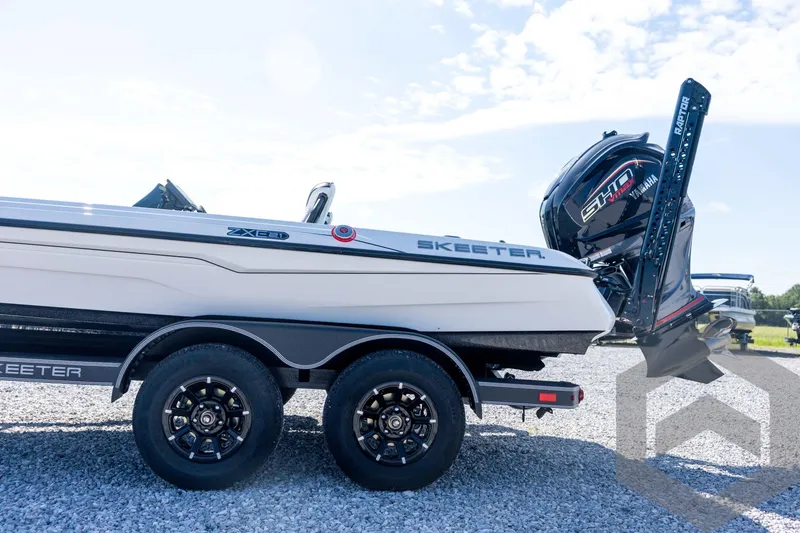 Slide: The Image of 2026 Skeeter ZXE21 boat with Yamaha engine on a trailer, parked on gravel. - 31