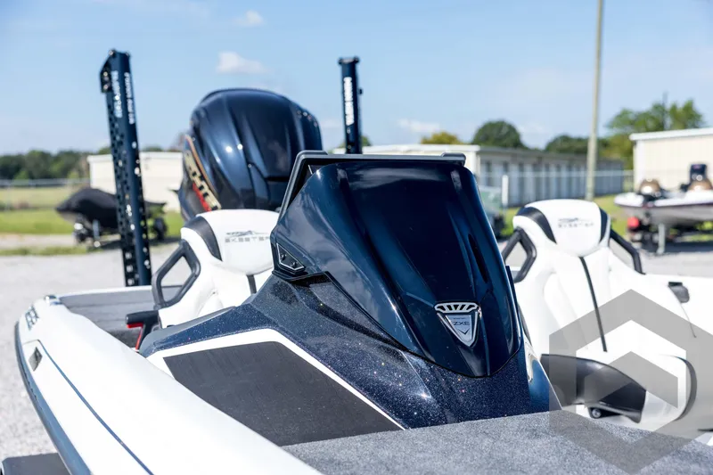 Slide: The Image of 2026 Skeeter ZXE21 boat with sleek design and modern features, parked outdoors. - 36