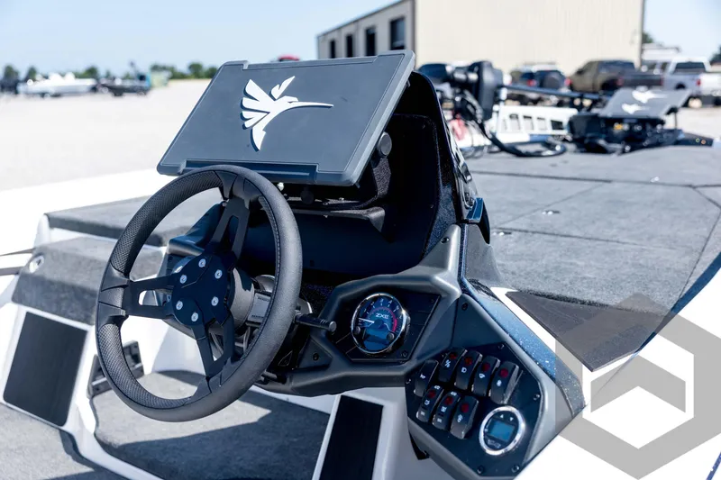 Slide: The Image of 2026 Skeeter ZXE21 boat dashboard with steering wheel and control panel. - 37