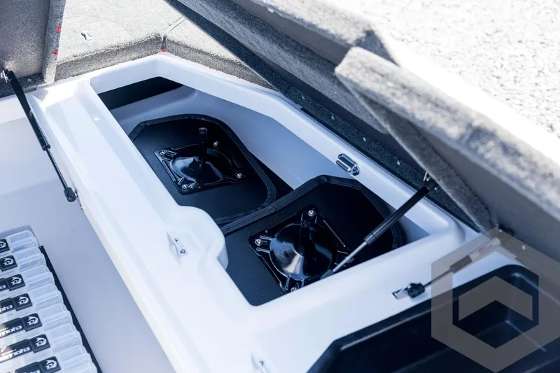 Slide: The Image of 2026 Skeeter ZXE21 boat storage compartment with organized tackle boxes and hydraulic lift. - 48