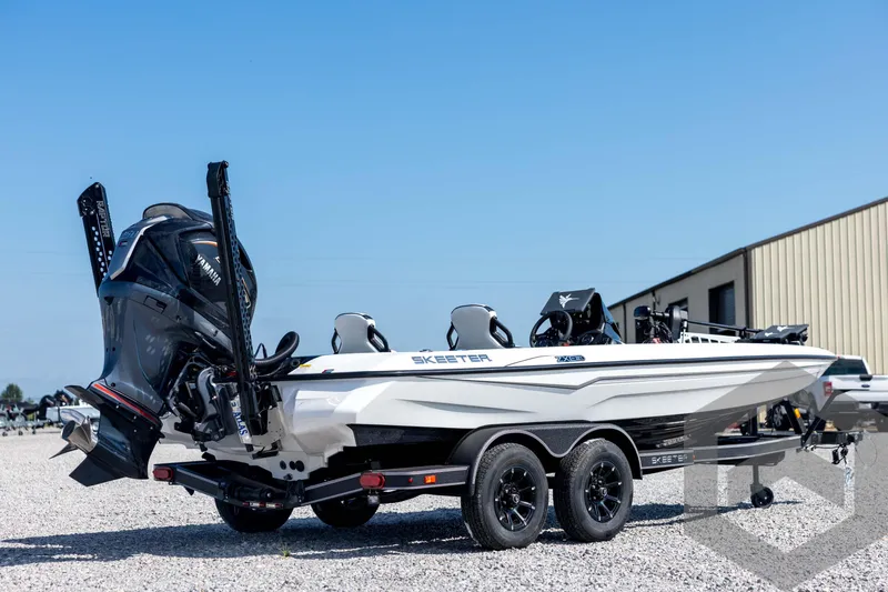 Slide: The Image of 2026 Skeeter ZXE21 boat with Yamaha engine on trailer, parked outdoors. - 5