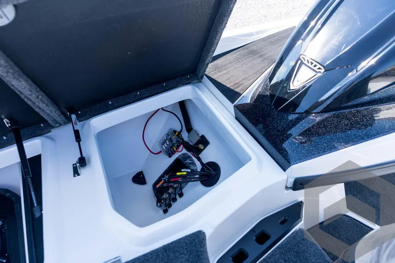 Slide: The Image of Open storage compartment in 2026 Skeeter ZXE21 boat, showing wiring and components. - 50