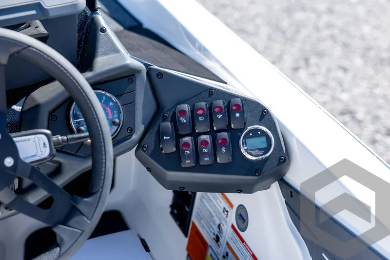 Slide: The Image of Control panel of 2026 Skeeter ZXE21 boat with steering wheel and switches. - 62