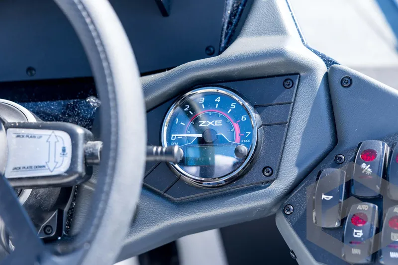 Slide: The Image of 2026 Skeeter ZXE21 dashboard with RPM gauge and control panel. - 64