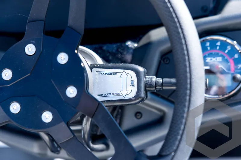Slide: The Image of Steering wheel and controls of 2026 Skeeter ZXE21 boat, featuring jack plate adjustment. - 65
