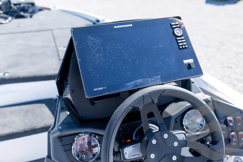Slide: The Image of 2026 Skeeter ZXE21 boat dashboard with Humminbird Xplore 12 display and steering wheel. - 67