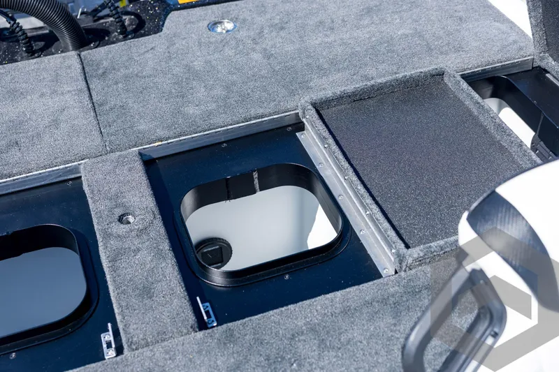 Slide: The Image of 2026 Skeeter ZXE21 boat storage compartments with carpeted lids and sleek design. - 72