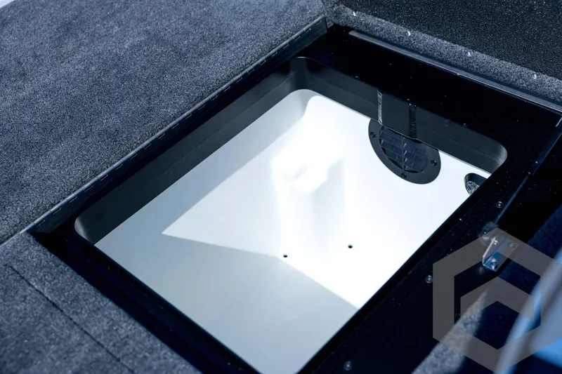 Slide: The Image of 2026 Skeeter ZXE21 boat storage compartment with carpeted interior and ventilation. - 73