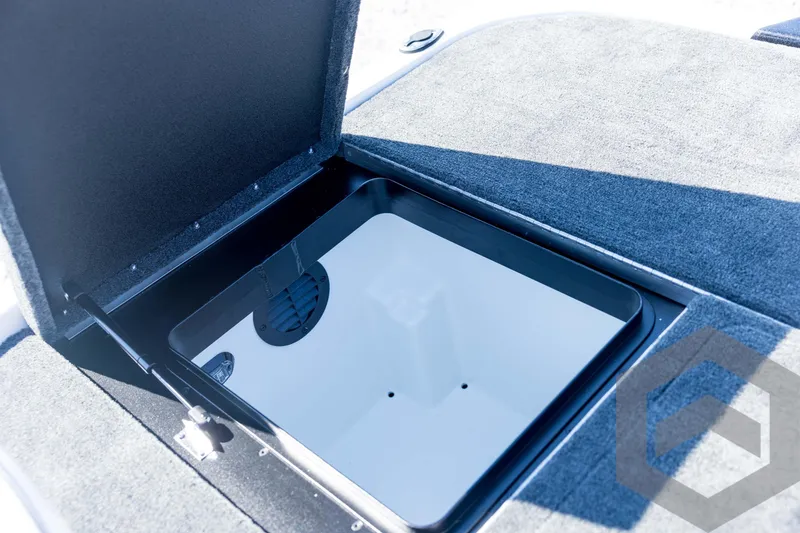 Slide: The Image of Open storage compartment in 2026 Skeeter ZXE21 boat, featuring carpeted interior. - 74